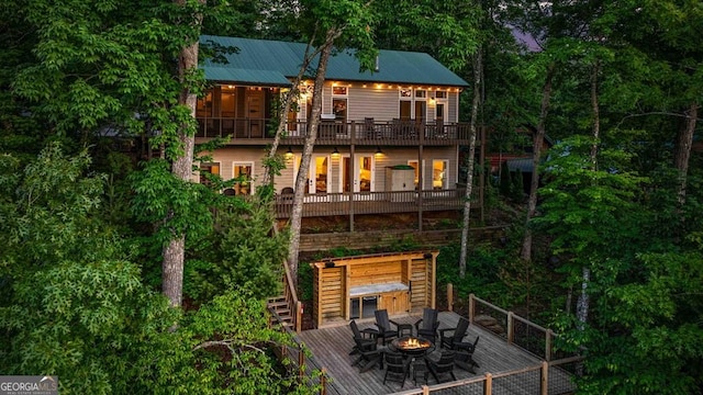 128 Overlake Ct, Morganton, GA 30560 - rear view of property with a fire pit, a balcony, a wooden deck, and a metal roof