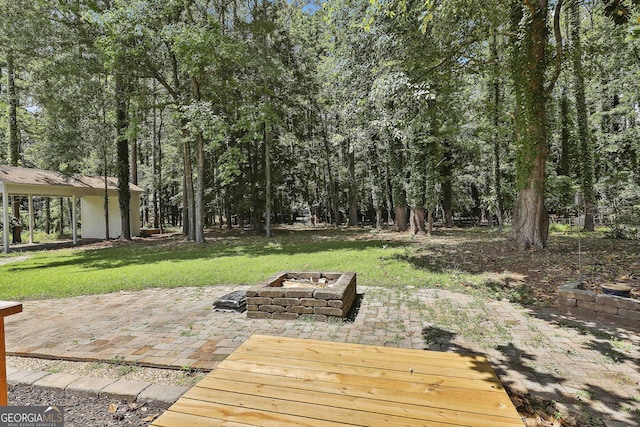 205 Shadowood Ln, Peachtree City, GA 30269 - wooden deck with a fire pit, a patio area, and a lawn