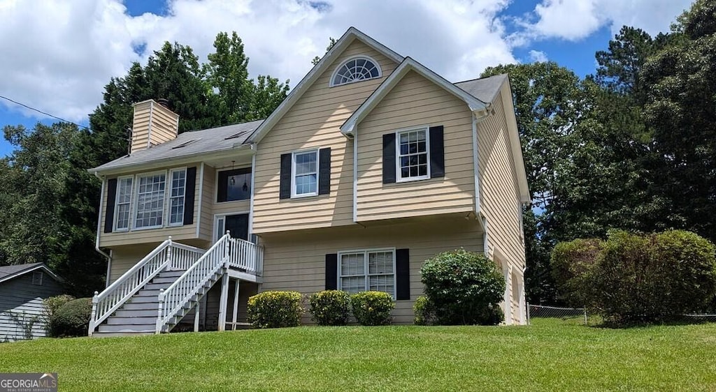9230 Melody Cir SW, Covington, GA 30014 - bi-level home with a front yard, a chimney, and stairs