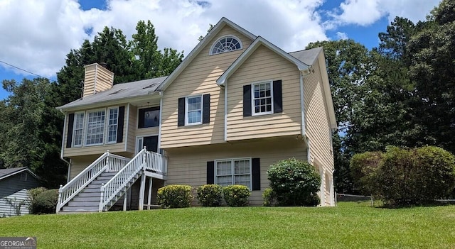 9230 Melody Cir SW, Covington, GA 30014 - bi-level home with a front yard, a chimney, and stairs