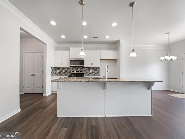 36 Crescent Chase, Dallas, GA 30157 - kitchen with stainless steel appliances, white cabinetry, dark wood-style floors, an island with sink, and a breakfast bar