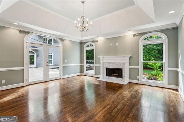 750 Crest Valley Dr NW, Sandy Springs, GA 30327 - unfurnished living room featuring a raised ceiling, a chandelier, plenty of natural light, wood finished floors, and crown molding
