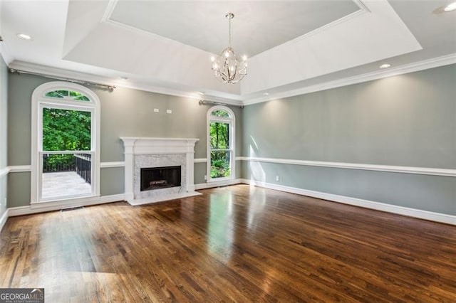 750 Crest Valley Dr NW, Sandy Springs, GA 30327 - unfurnished living room with a raised ceiling, a chandelier, crown molding, wood finished floors, and a premium fireplace