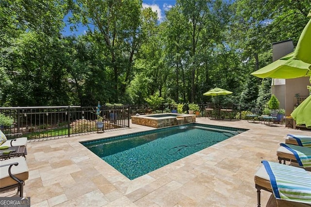 750 Crest Valley Dr NW, Sandy Springs, GA 30327 - view of swimming pool featuring a patio, a pool with connected hot tub, and view of wooded area