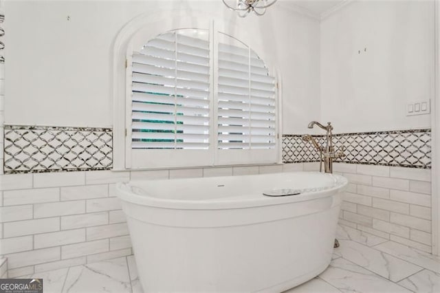 750 Crest Valley Dr NW, Sandy Springs, GA 30327 - full bathroom featuring marble look tiles, tile walls, a freestanding bath, ornamental molding, and wainscoting