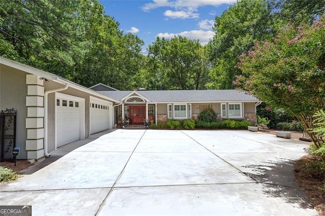 750 Crest Valley Dr NW, Sandy Springs, GA 30327 - single story home with an attached garage, concrete driveway, stone siding, and stucco siding