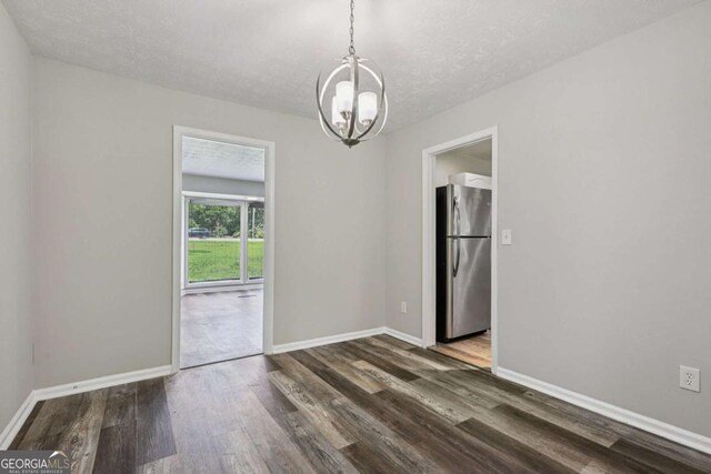 2849 Snapfinger Rd, Decatur, GA 30034 - unfurnished room featuring a chandelier, wood finished floors, and a textured ceiling