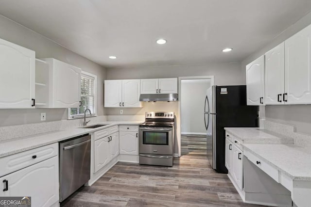 2849 Snapfinger Rd, Decatur, GA 30034 - kitchen with stainless steel appliances, under cabinet range hood, white cabinetry, recessed lighting, and wood finished floors