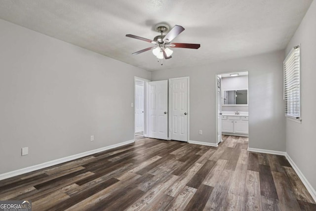 2849 Snapfinger Rd, Decatur, GA 30034 - unfurnished bedroom featuring dark wood finished floors, ensuite bath, and a ceiling fan