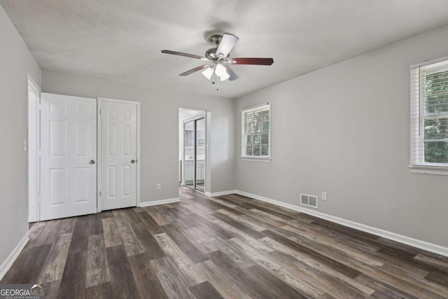 2849 Snapfinger Rd, Decatur, GA 30034 - unfurnished bedroom with dark wood-style flooring, ensuite bathroom, and a ceiling fan