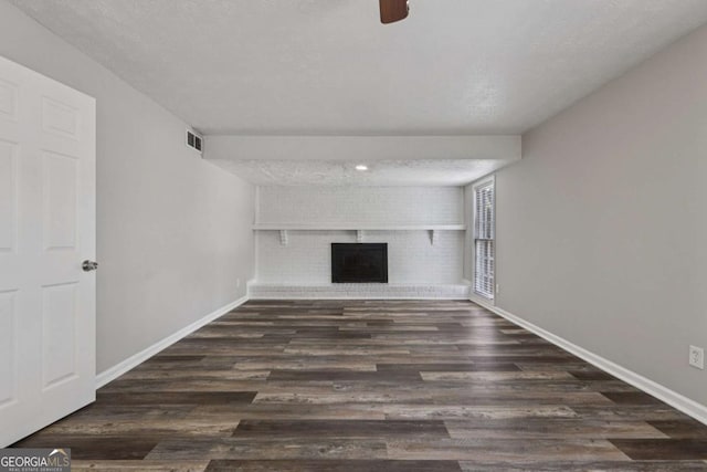 2849 Snapfinger Rd, Decatur, GA 30034 - unfurnished living room featuring a brick fireplace, wood finished floors, and a ceiling fan