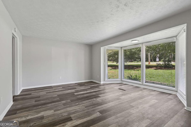 2849 Snapfinger Rd, Decatur, GA 30034 - empty room with dark wood-type flooring and a textured ceiling
