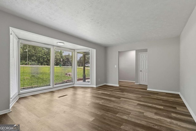 2849 Snapfinger Rd, Decatur, GA 30034 - spare room with wood finished floors and a textured ceiling