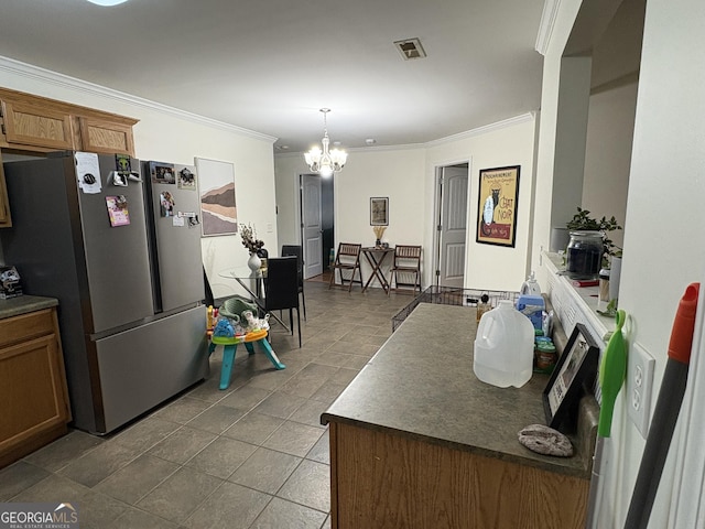 44 Hawk Spring Dr SW, Rome, GA 30165 - kitchen with freestanding refrigerator, ornamental molding, a chandelier, brown cabinetry, and dark countertops
