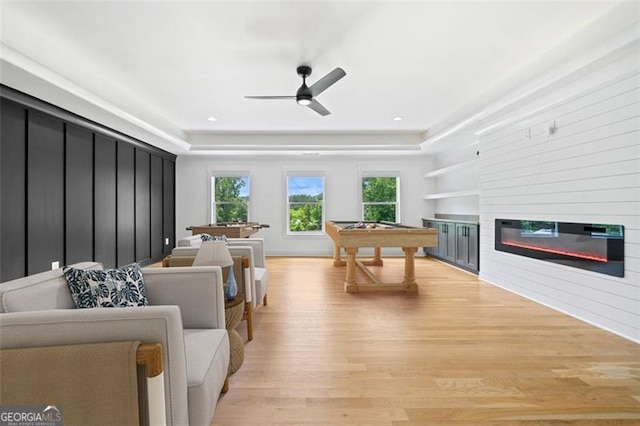 103 Maddox Rd, Buford, GA 30518 - recreation room featuring light wood-style floors, a large fireplace, ceiling fan, and a tray ceiling