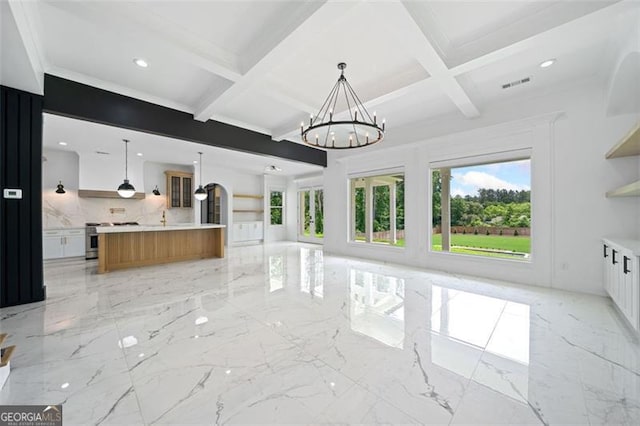 103 Maddox Rd, Buford, GA 30518 - unfurnished living room featuring a chandelier, plenty of natural light, coffered ceiling, light marble finish flooring, and beam ceiling