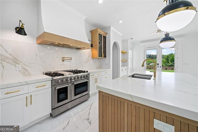 103 Maddox Rd, Buford, GA 30518 - kitchen featuring range with two ovens, custom exhaust hood, french doors, light marble finish floors, and recessed lighting