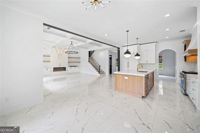 103 Maddox Rd, Buford, GA 30518 - kitchen with high end range, open floor plan, recessed lighting, arched walkways, and light marble finish flooring