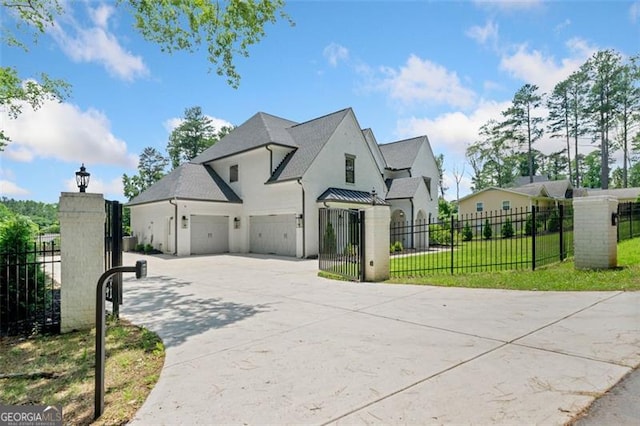 103 Maddox Rd, Buford, GA 30518 - french country inspired facade featuring driveway, stucco siding, a standing seam roof, and a garage
