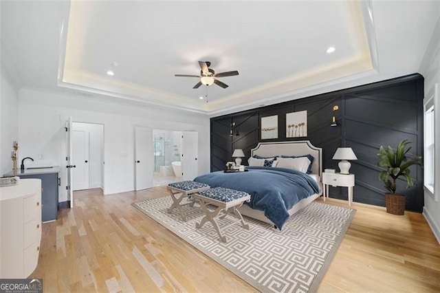 103 Maddox Rd, Buford, GA 30518 - bedroom featuring a tray ceiling, light wood-style floors, recessed lighting, ensuite bathroom, and a ceiling fan