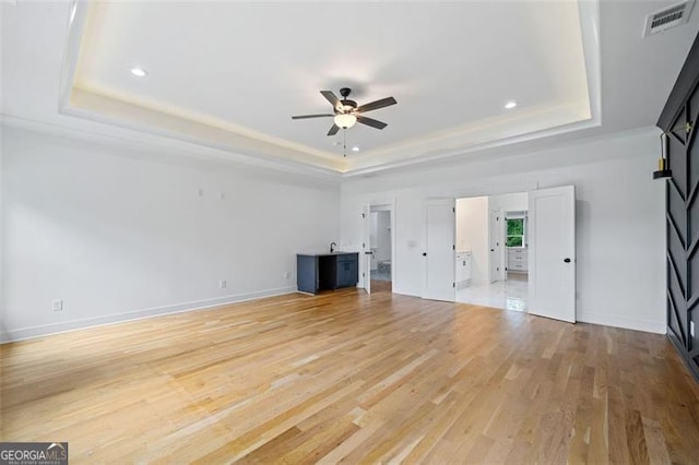 103 Maddox Rd, Buford, GA 30518 - unfurnished living room with a raised ceiling, a ceiling fan, light wood finished floors, and recessed lighting