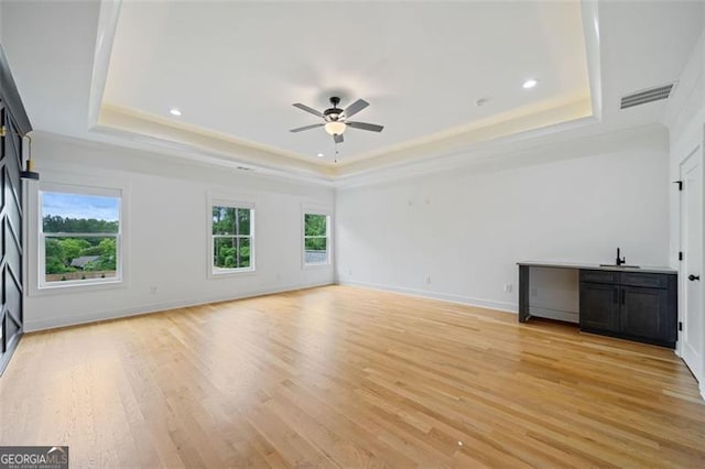 103 Maddox Rd, Buford, GA 30518 - unfurnished living room with a tray ceiling, a ceiling fan, light wood-style floors, recessed lighting, and crown molding