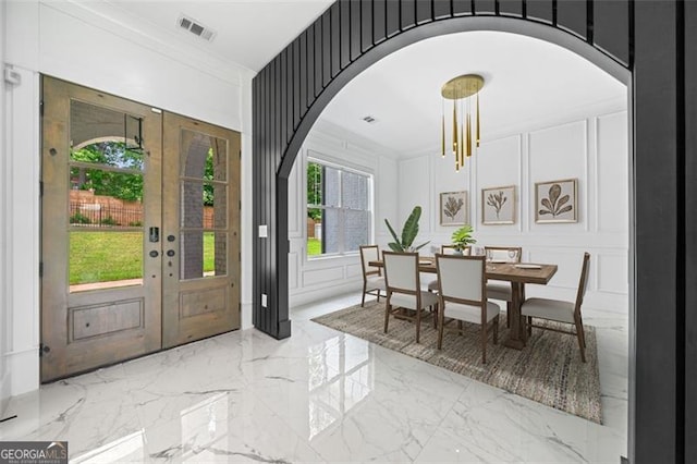 103 Maddox Rd, Buford, GA 30518 - entryway with a decorative wall, arched walkways, marble tiled floors, and crown molding