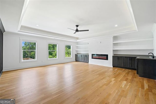 103 Maddox Rd, Buford, GA 30518 - unfurnished living room featuring a raised ceiling, ceiling fan, and light wood finished floors
