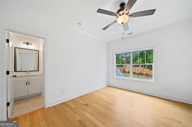 103 Maddox Rd, Buford, GA 30518 - unfurnished bedroom featuring light wood-style floors, ensuite bathroom, and ceiling fan