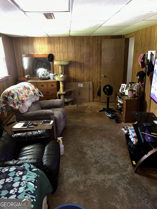 90 Cabriolet Trl, Mcdonough, GA 30253 - living area with wooden walls, concrete floors, and a paneled ceiling
