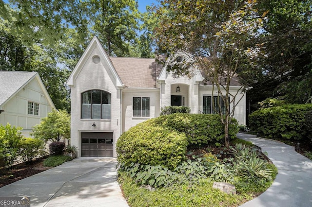 1833 N Rock Springs Rd NE, Atlanta, GA 30324 - view of front of property with an attached garage, concrete driveway, and brick siding