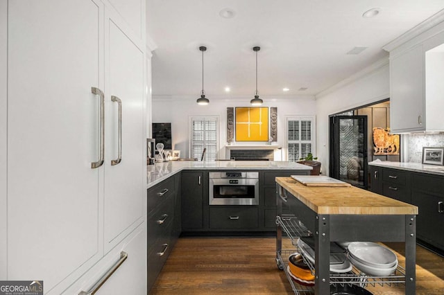 1833 N Rock Springs Rd NE, Atlanta, GA 30324 - kitchen with oven, butcher block countertops, ornamental molding, dark cabinetry, and dark wood-style flooring