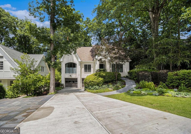1833 N Rock Springs Rd NE, Atlanta, GA 30324 - view of front of home with driveway, an attached garage, and stucco siding