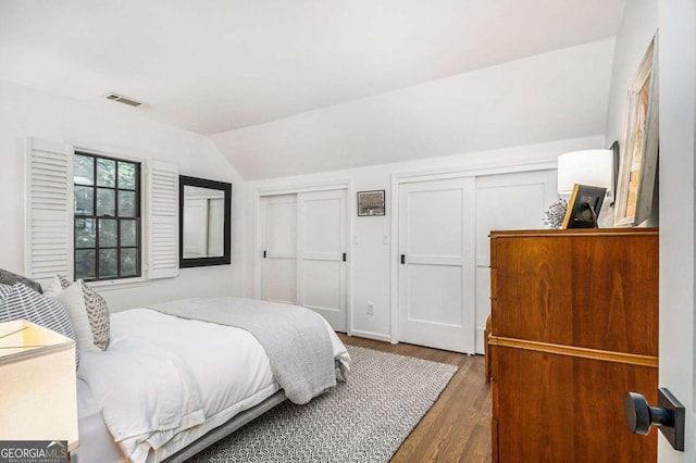 1833 N Rock Springs Rd NE, Atlanta, GA 30324 - bedroom with two closets, wood finished floors, and vaulted ceiling