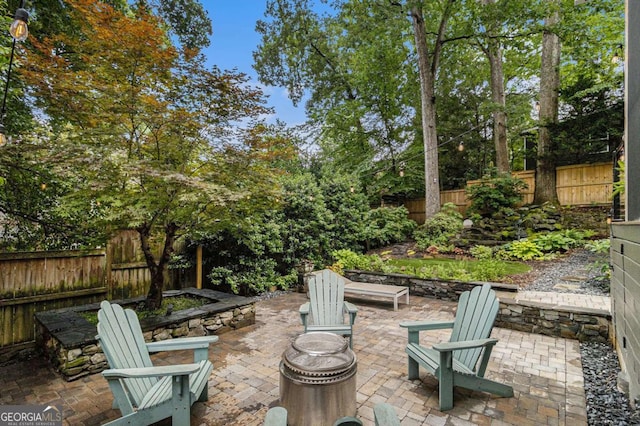 1833 N Rock Springs Rd NE, Atlanta, GA 30324 - fenced backyard featuring a patio area and an outdoor fire pit
