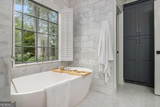 1833 N Rock Springs Rd NE, Atlanta, GA 30324 - bathroom with tile walls, a soaking tub, tile patterned floors, and a closet