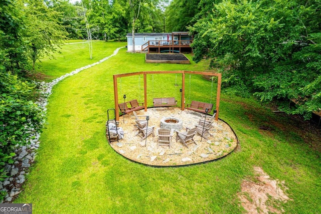 103 Fawn Ct, Eatonton, GA 31024 - view of grassy yard with a fire pit and a wooden deck
