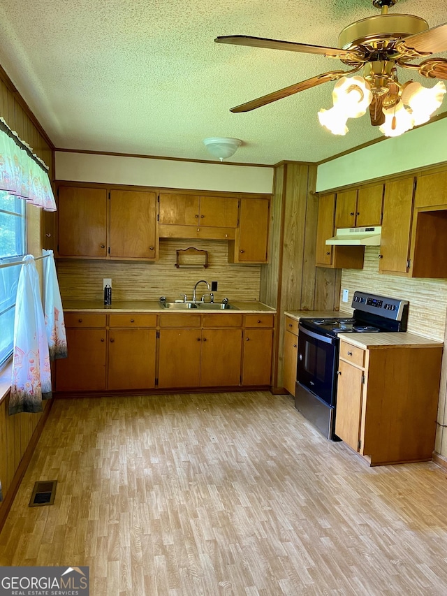 6617 18th St SW, Lanett, AL 36863 - kitchen featuring black / electric stove, a textured ceiling, a ceiling fan, tasteful backsplash, and light countertops