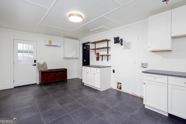 101 Pawnee St, Waleska, GA 30183 - kitchen with a wall mounted AC, dark tile patterned flooring, white cabinets, and dark countertops