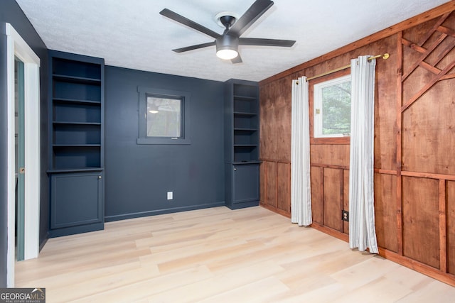 101 Pawnee St, Waleska, GA 30183 - unfurnished bedroom with wood finished floors, wood walls, and a ceiling fan