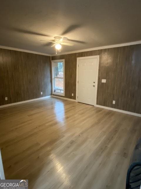 120 Foothill Dr, Dalton, GA 30720 - unfurnished living room with wood walls, wood finished floors, a ceiling fan, and ornamental molding