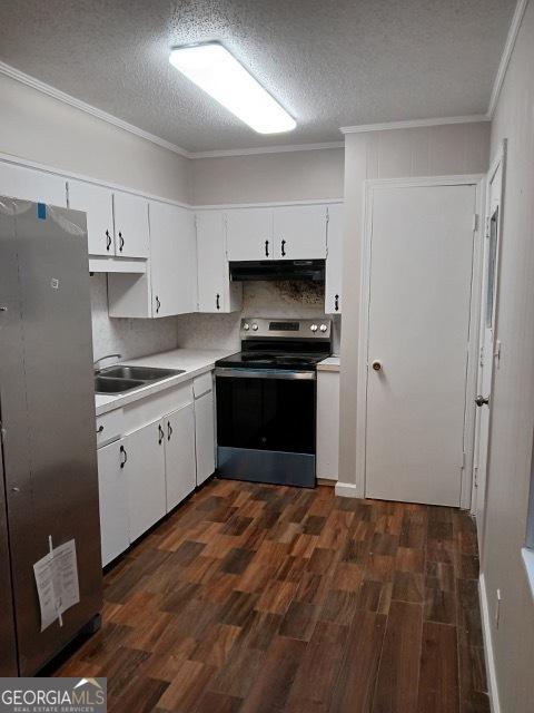 120 Foothill Dr, Dalton, GA 30720 - kitchen with appliances with stainless steel finishes, under cabinet range hood, dark wood-type flooring, ornamental molding, and a textured ceiling