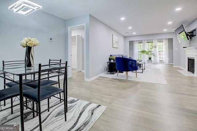 24317 Plantation Dr NE, Atlanta, GA 30324 - dining space featuring wood finished floors, recessed lighting, a chandelier, and a fireplace