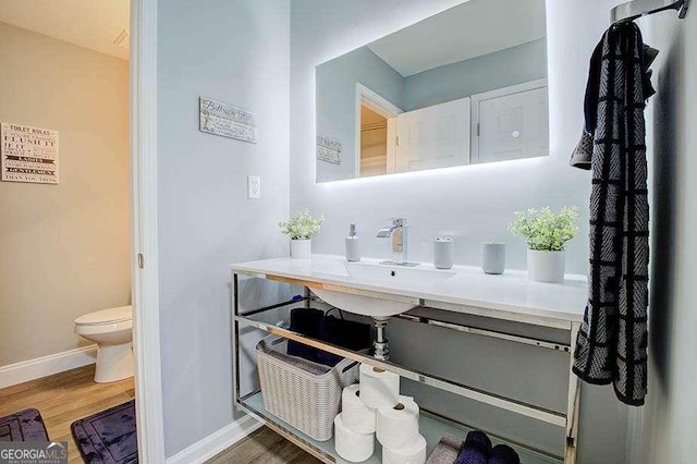24317 Plantation Dr NE, Atlanta, GA 30324 - bathroom featuring wood finished floors and vanity