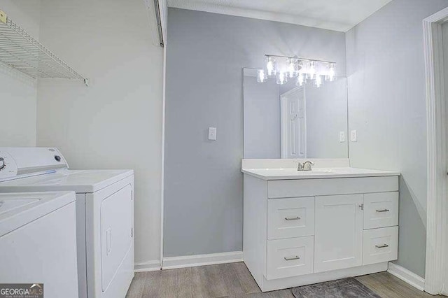 24317 Plantation Dr NE, Atlanta, GA 30324 - full bathroom featuring wood finished floors, washer and dryer, and vanity