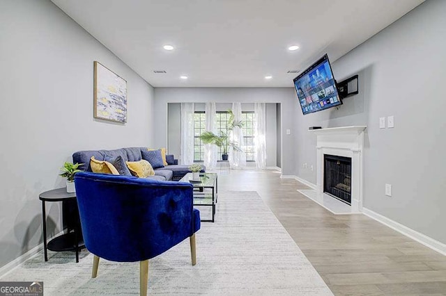 24317 Plantation Dr NE, Atlanta, GA 30324 - living area featuring a fireplace, wood finished floors, and recessed lighting