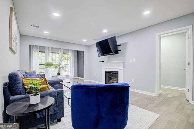 24317 Plantation Dr NE, Atlanta, GA 30324 - living area featuring a fireplace, light wood-style floors, and recessed lighting