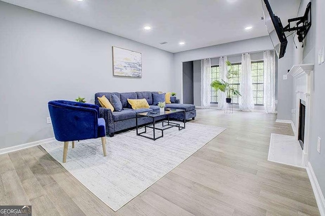 24317 Plantation Dr NE, Atlanta, GA 30324 - living room with light wood-style floors, recessed lighting, and a fireplace