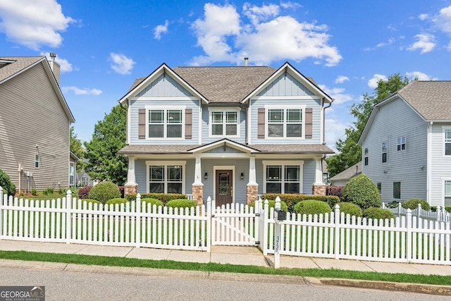 3725 Downing Dr, Cumming, GA 30040 - craftsman house featuring board and batten siding, covered porch, a fenced front yard, a gate, and a shingled roof