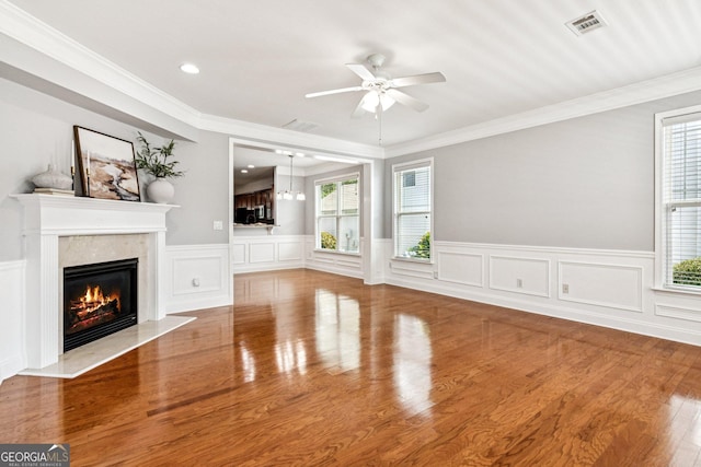 3725 Downing Dr, Cumming, GA 30040 - unfurnished living room with healthy amount of natural light, a premium fireplace, a ceiling fan, wood finished floors, and a wainscoted wall